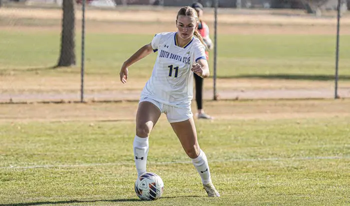 Woman dribbling soccer ball